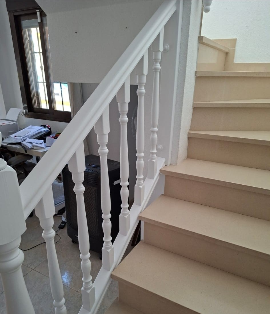 Finished white staircase handrail, spindles and newel posts