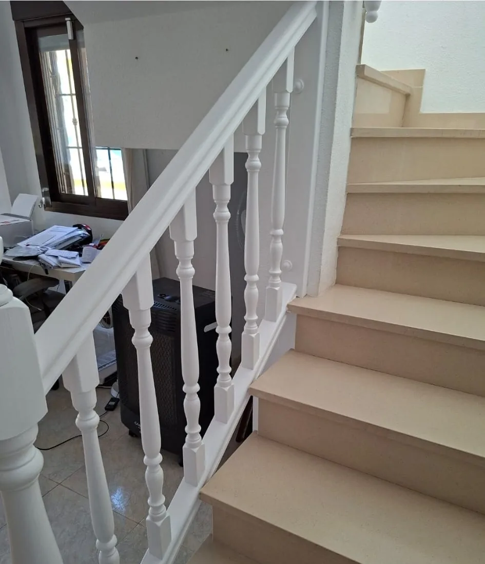 Finished white staircase handrail, spindles and newel posts